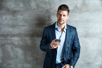 Good-looking young businessman with mobile phone