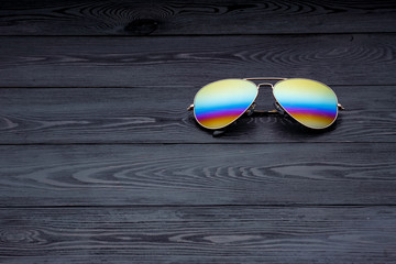 aviators sunglasses with mirrored color lenses made of glass in a gold metal frame covered with...