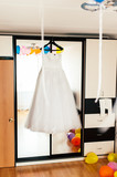 wedding dress on a hanger on a mirror closet