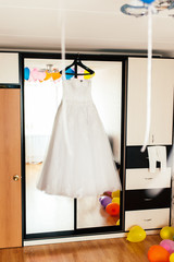 wedding dress on a hanger on a mirror closet