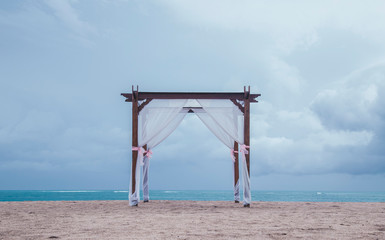 Beautiful and Romatic wedding arch tent on the beach by the sea