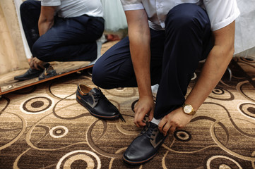 The man ties up his shoe