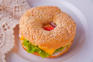 Fresh healthy bagel sandwich on a white plate