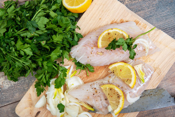 Fresh fish, raw cod fillets with addition of herbs and lemon