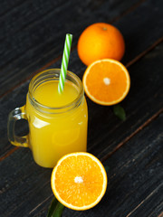 Obraz na płótnie Canvas Fresh bright homemade orange juice on wooden table close up