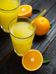 Fresh bright homemade orange juice on wooden table close up