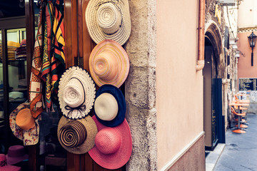 Naklejka premium hats for sale in a shop of Taormina, Sicily, Italy.