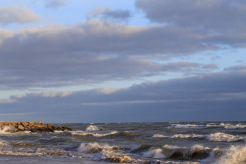 sea with waves against a cloudy sky
