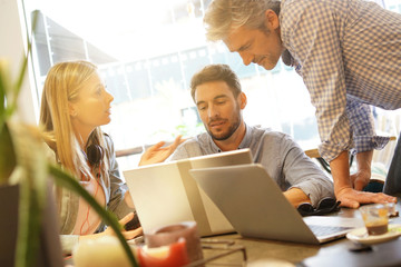 Colleagues discussing ideas in coworking space