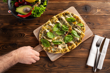 pizza with chicken, mushrooms and cheese on a wooden background