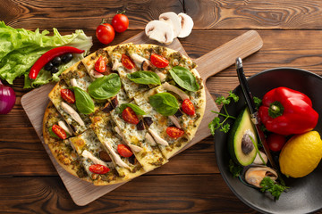 pizza with shiitake chicken and mushrooms on wooden background