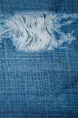 Blue Jean texture with a hole and threads.