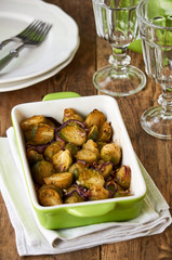 Baked brussels sprouts with red onions in ceramic form   