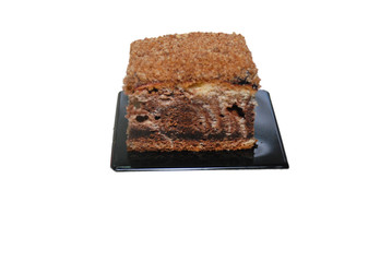 zebra cake made of brown and white dough mixed as layers on the black plastic disposal stand