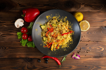 jasmine rice with curry chicken in a black plate on wooden background