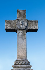marble cross with the face of Jesus in relief