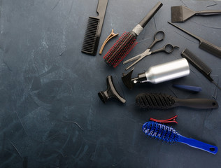 Top view of professional hair dresser tools on black  background