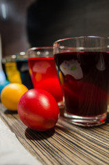 cups with colored water and easter eggs