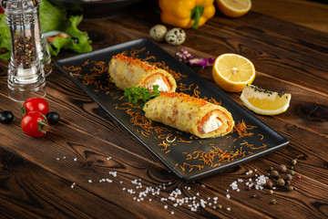 Chinese salmon rosti in black plate on wooden background