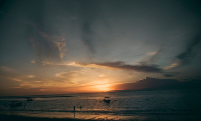 Fototapeta na wymiar beautiful sunset on tropical beach by the sea in Bali