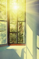 Sunbeams passing through vintage window into room