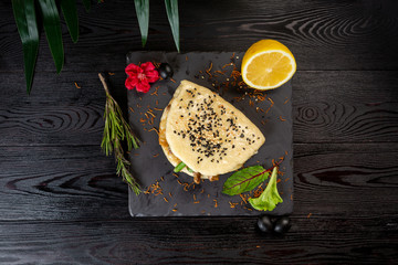 bao with lamb on a black plate on a wooden background