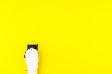 White electric clippers barber on yellow background. Hairdresser salon concept, Hairdressing Set. Haircut accessories. Copy space image, flat lay.