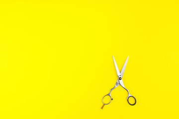 Stylish Professional Barber Scissors on yellow background. Hairdresser salon concept, Hairdressing Set. Haircut accessories. Copy space image, flat lay.