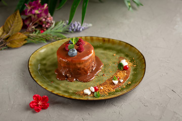 pancake with melted chocolate and berries on a green plate