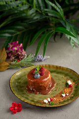 pancake with melted chocolate and berries on a green plate