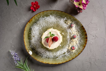 milk dessert with fruit and chocolate on a green plate