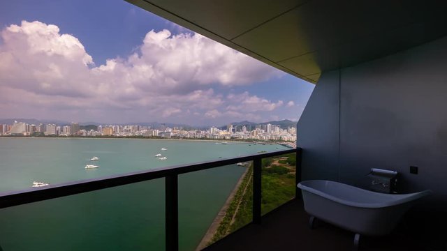 sunny sky sanya city bay boat famous hotel resort balcony panorama 4k timelapse hainan island china