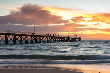 Fototapeta premium A beautiful sunset at Port Noarlunga with the jetty and motion blur on the water at Port Noarlunga South Australia on 18th March 2019