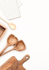Wooden kitchen utensils on white background. Flat lay, top view.