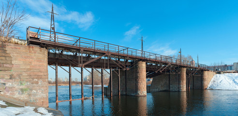 Kommunar dam, a pedestrian bridge over the Miass river