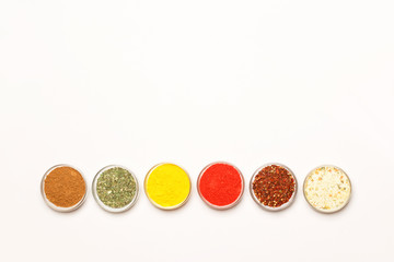 Condiments and herbs on white background. Flat lay. Top view.
