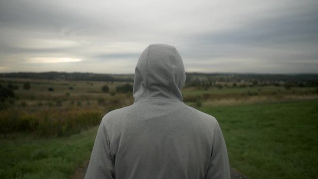 Man is looking on valley. Med shot.