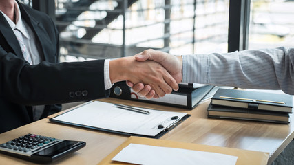 Handshake after finishing conversation Businessman sending a resignation letter to employer boss in...