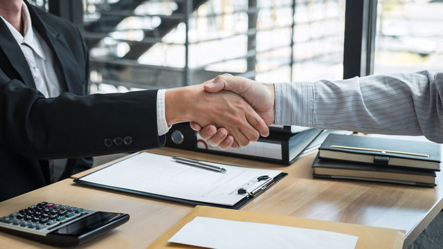 Handshake after finishing conversation Businessman sending a resignation letter to employer boss in order to resign dismiss contract, changing and resigning from work concept