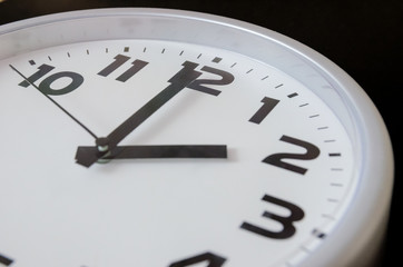 Close up of black and white analog clock with selective focus at 2 Oclock. Time concept
