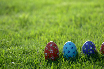 Handmade Painted Easter eggs on green spring grass. Space for text