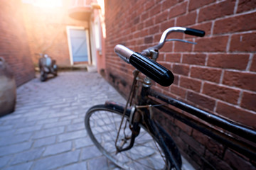 Fototapeta na wymiar Antique bike with red brick background. Vintage concept