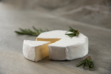 Fototapeta na wymiar Cheese camembert or brie with fresh rosemary