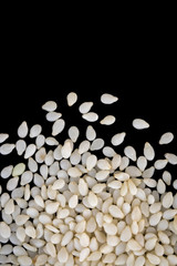 image of white sesame seeds isolated on black background. Food.