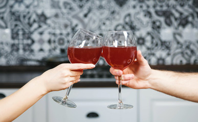 Sexy girl on the table cheers with her love sitting at the table