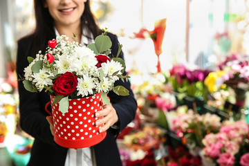 Fototapeta premium Female owner with beautiful flowers in shop