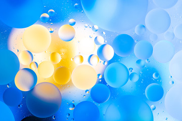 oily drops  in water with colorful background, close-up