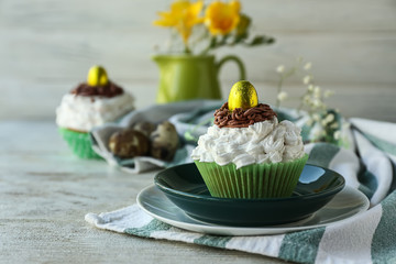 Tasty Easter cupcake on table