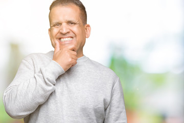Fototapeta premium Middle age arab man wearing sport sweatshirt over isolated background looking confident at the camera with smile with crossed arms and hand raised on chin. Thinking positive.