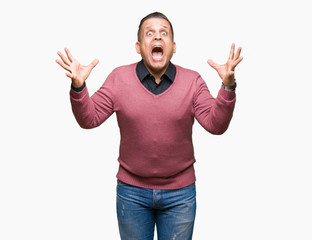 Fototapeta premium Middle age arab man over isolated background celebrating crazy and amazed for success with arms raised and open eyes screaming excited. Winner concept